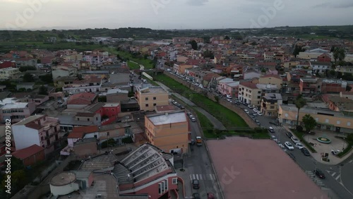 Wallpaper Mural Aerial orbit of Italian town Sestu, CA, Mediterranean Sea, Italy, Europe. River crossing the town. Cars crossing the bridge. Countryside in the background. Torontodigital.ca