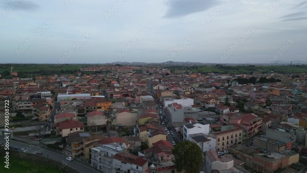 Aerial orbit of Italian town Sestu, CA, Mediterranean Sea, Italy, Europe. River crossing the town. Countryside in the background. Beautiful european buildings. Car moving and traffic. Aerial orbit of Italian town Sestu, CA, Mediterranean Sea, Italy, Europe. River crossing the town. Countryside in the background. Beautiful european buildings. Car moving and traffic.