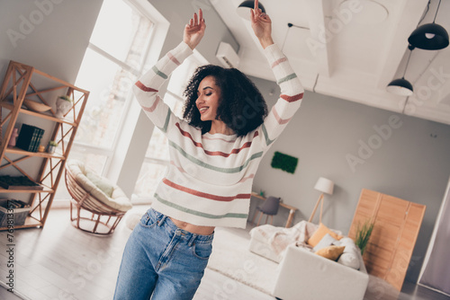 Photo of good mood adorable lady dressed striped pullover having fun indoors apartment room