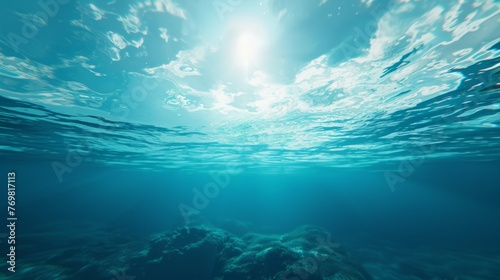 Underwater background featuring a deep blue sea with beautiful light rays piercing through the water photo
