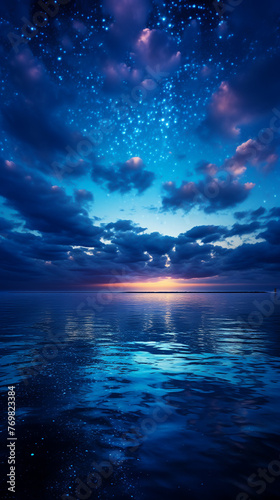 Big blue night sky with full moon above quiet sea  twilight glow  high angle  peaceful horizon