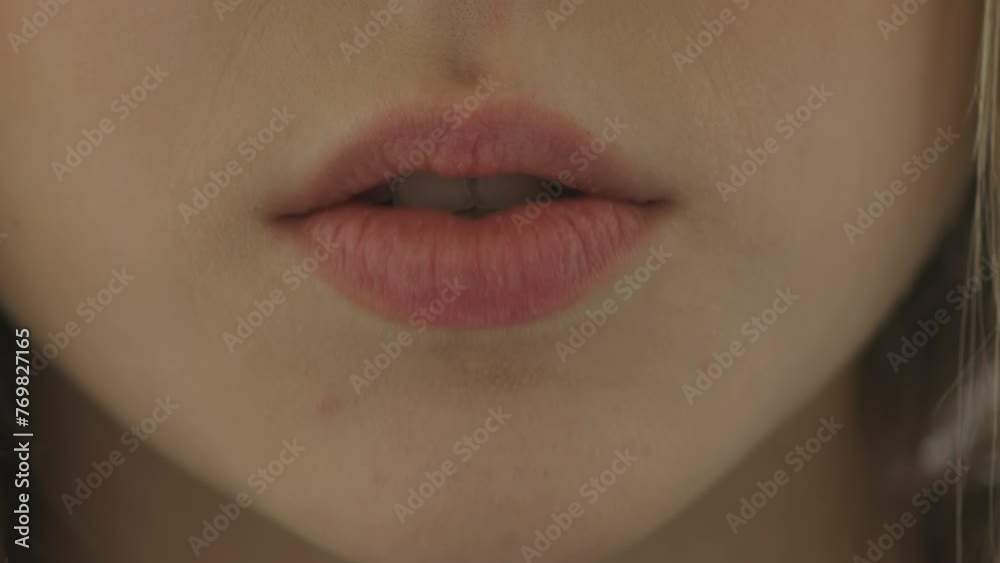 Unrecognizable girl moves her lips close-up. Female lips says something or sings a song