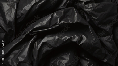 full frame abstract background of crumpled black plastic film bag © Fabian