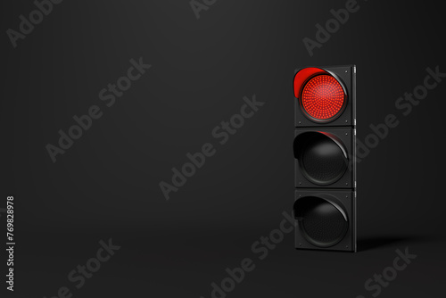 Red traffic signal shining in the darkness