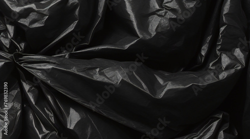 full frame abstract background of crumpled black plastic film bag photo
