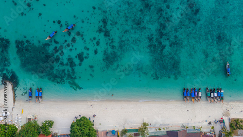 Long beach at Koh Phi Phi island, Krabi, Thailand. Tropical paradise white sand beach with turquoise waters of Andaman sea, aerial view.