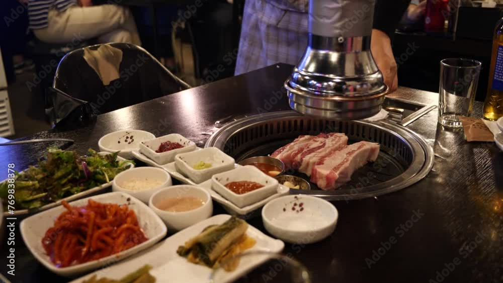 Typical korean bbq grill. Korean barbecue cooked and served at a restuarant in Seoul, South Korea. High quality 4k footage