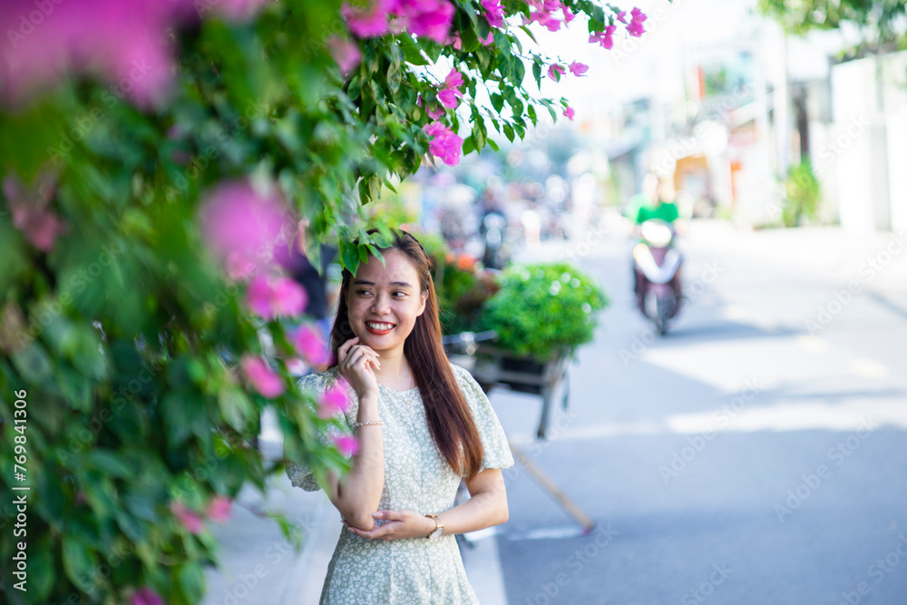 Cute model with outfit revealing hot spots on her body. Pretty model girl standing near the red peach tree in the garden. Cute model with outfit revealing hot spots on her body. Pretty model girl standing near the red peach tree in the garden.
