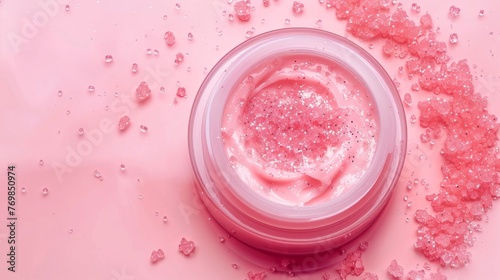 The jar contains a moisturizing beauty cream and bright pastel pink water. This is a top view with copy space.