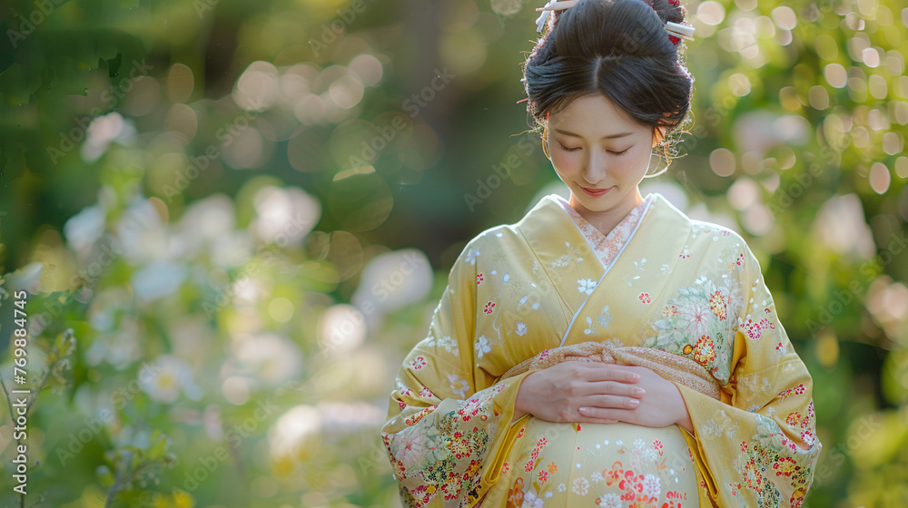 A Japanese woman in her final trimester wearing a soft yellow kimono A Japanese woman in her final trimester wearing a soft yellow kimono