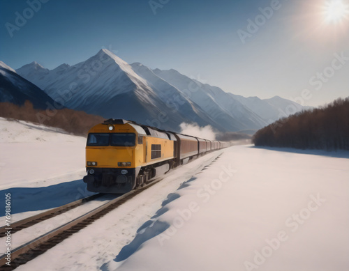 Train moving across snow-covered plain against the backdrop of high mountains on a bright sunny day.