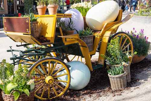 Photography Easter decoration of a carriage with large decorative Easter eggs in a city park