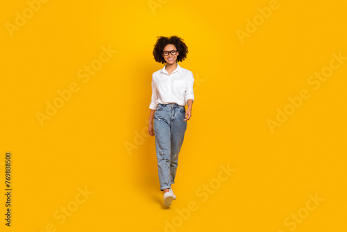 Full length body size view of attractive smart cheerful girl assistant going isolated over bright yellow color background