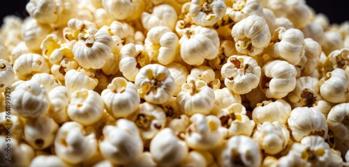  A white popcorn pile sits atop a black table, adjacent to brown and white popcorn piles