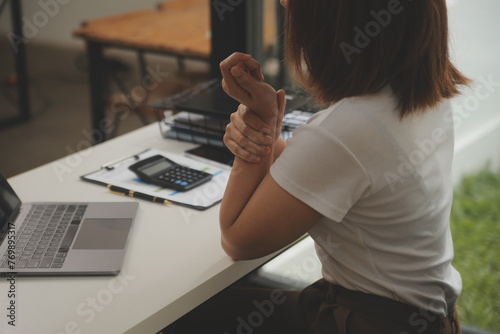 Shot of a asian young business Female working on laptop in her workstation.