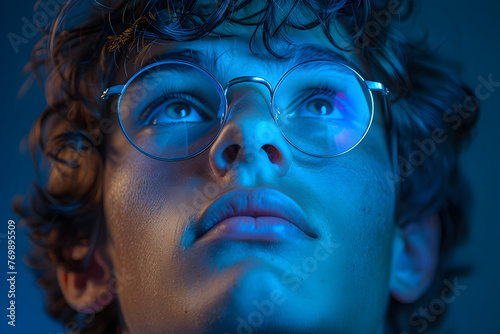 Innovation Gaze: Young Man Reflecting Blue Light