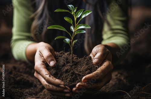 Close-up photo of two human hands holding soil and green plant. World Environment Day,  Earth Day, enviromental issues, carbon footprint, environment, agriculture, ecology, gardening, seedling