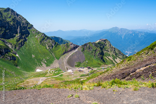 View of the Caucasus mountains from the peak "Black Pyramid" in summer on a sunny day - panorama