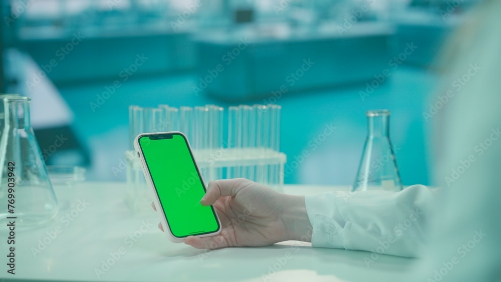 Smartphone with Green Screen on Research Biochemistry lab Desk. Advertising area, workspace mock up. Smartphone with Green Screen on Research Biochemistry lab Desk. Advertising area, workspace mock up.