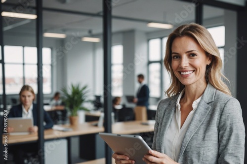 Happy businesswoman standing with tablet pc in office Free Download Happy businesswoman standing with tablet pc in office - GFXLoad