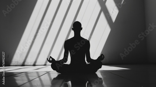 Silhouette of a man in the lotus position