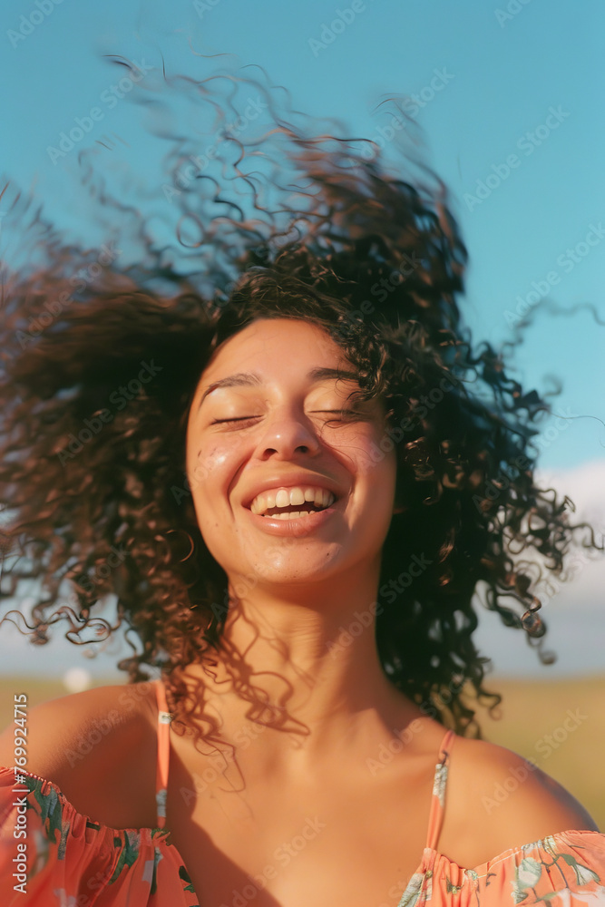 Joyful Woman with Curly Hair Enjoying Sunny Day Outdoors Joyful Woman with Curly Hair Enjoying Sunny Day Outdoors