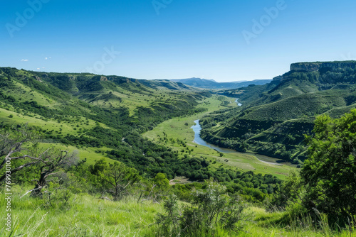 A beautiful green valley with a river running through it photo