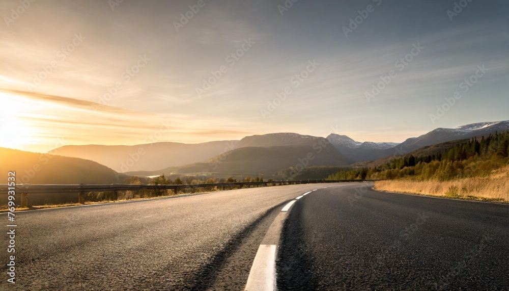 asphalt road and mountain range natural scenery at sunrise