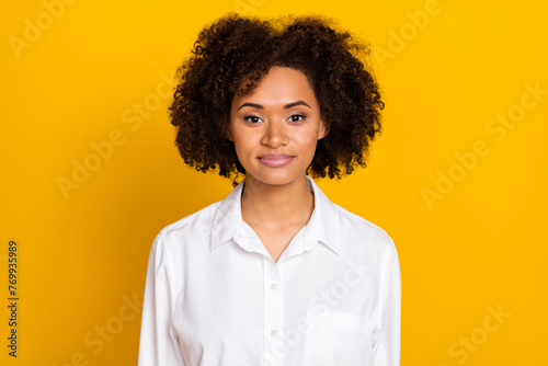 Portrait of attractive skilled cheerful wavy-haired girl expert wearing white shirt isolated over bright yellow color background