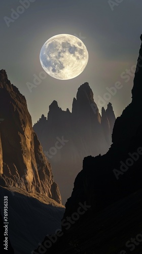 Twilight Serenade: Moon Embracing the Mountain’s Silhouette - In this captivating scene, the moon embraces the silhouette of a distant mountain range, creating a symphony of light and form.