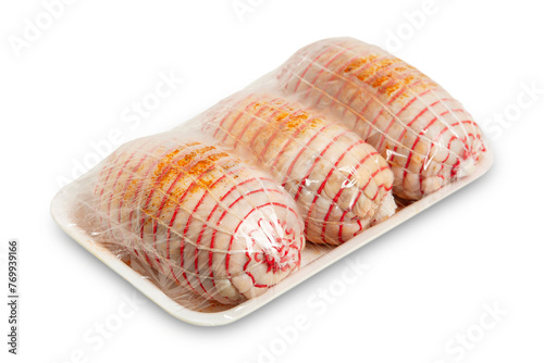 three raw chicken rolls in package isolated