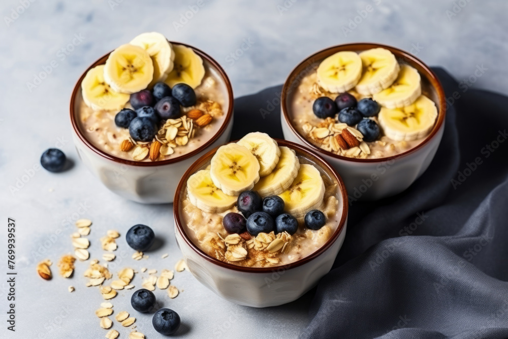 Breakfast oatmeal with banana and blueberry and slivered almonds, breakfast for two on the marble table Breakfast oatmeal with banana and blueberry and slivered almonds, breakfast for two on the marble table