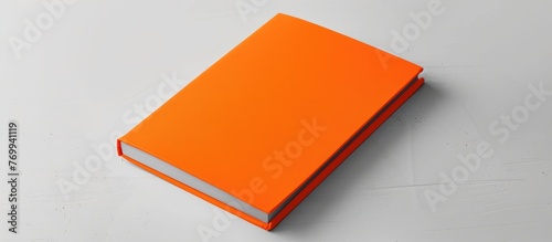 Notebook mockup in orange color displayed on a white background