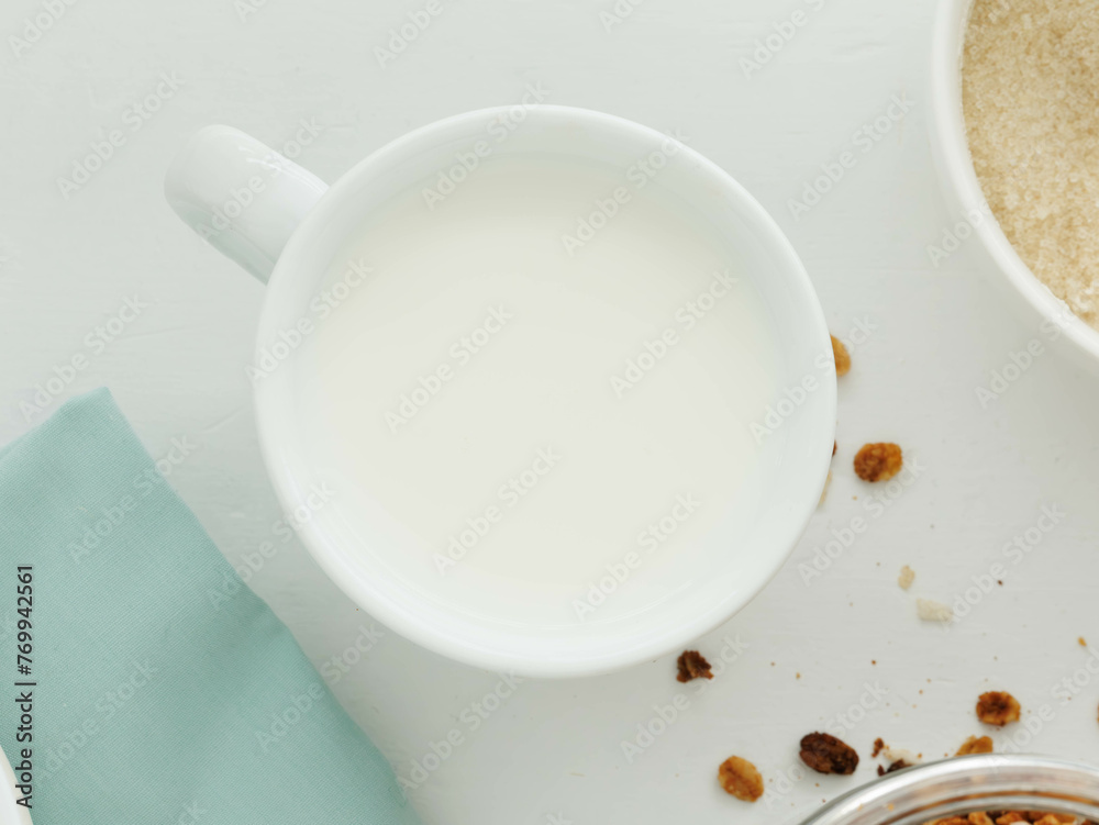Overhead view of white cup of filled with milk Overhead view of white cup of filled with milk