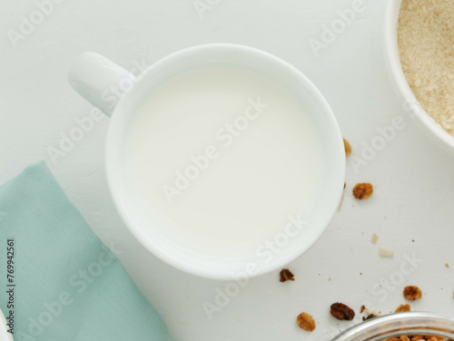 Overhead view of white cup of filled with milk