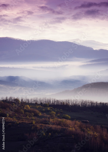 morning landscape with layers of hills and fog in the valley