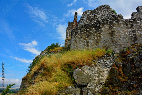 ruiny zamku na górze, castle, ruins of a castle on a hill against the blue sky  © kateej
