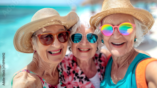Group of smiling Senior Women with sun hats and colorful sunglasses Taking a Selfie on a Tropical Beach
