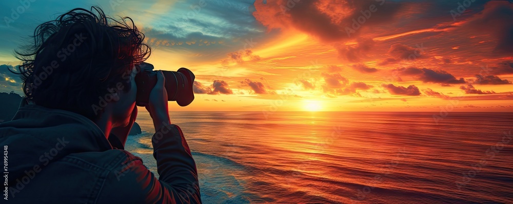 Photographer holds camera in his hands and focus the lens to capture a evening beach sunset shot