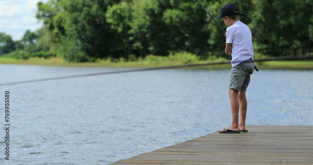 child boy fishing at lake