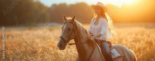 Cowboy woman on riding on horse. Beautiful cowgirl posing on prairie in sunset light. banner.