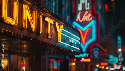 The word "UNITY" in the form of an old cinema marquee in a city with blurred streetlights in the background.