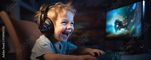 Happy boy is excited playing games on computer. Playing PC games concept