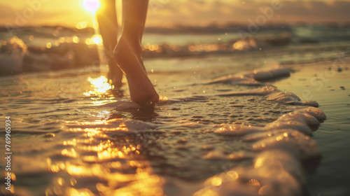 Close-up of Bare Feet Walking on Sandy Shore at Sunset