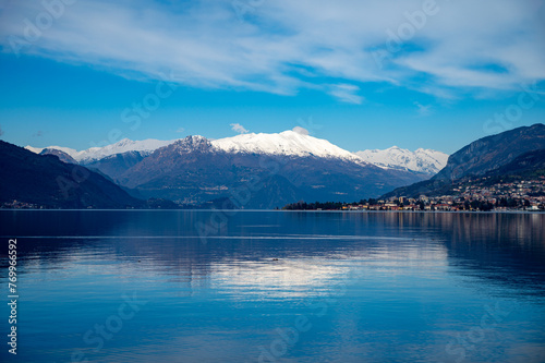 Driving car along shores of Lake Como in Northern Italy, spring sunny days, views of alpine mountains, water and villages © barmalini