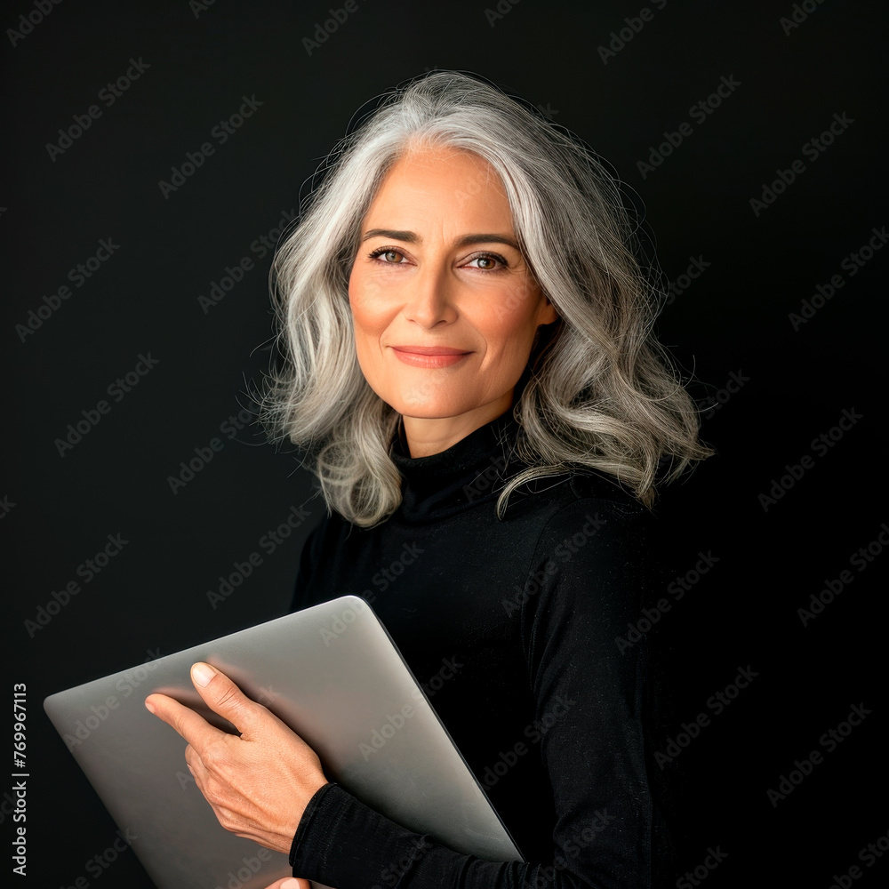 Portrait of a beautiful adult woman in a black turtleneck with a laptop in her hands on an isolated background. Portrait of a beautiful adult woman in a black turtleneck with a laptop in her hands on an isolated background.