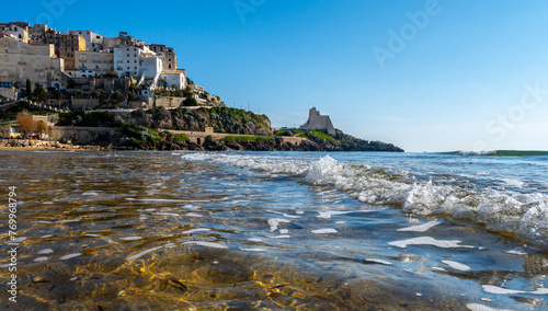 View on sandy beach and sea water in medieval small touristic coastal town Sperlonga and sea shore, Latina, Italy