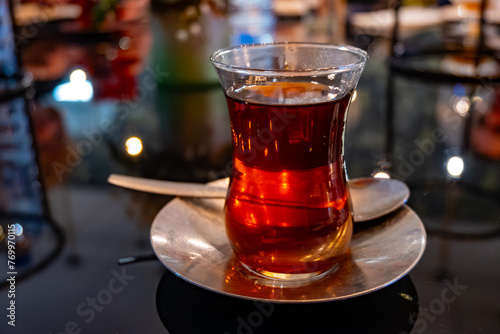Turkish sweet tea served in traditional glass in restaurant in Istanbul, Turkey photo