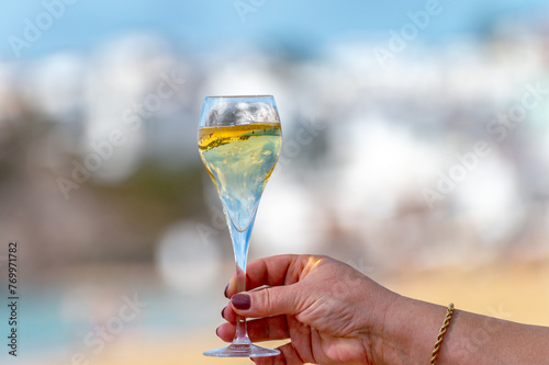 Pouring a glass of champagne on vacation, south of Fuerteventura, Canary islands, blue ocean, mountains photo