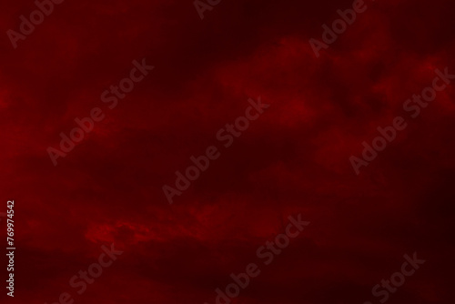 Red cloudy night sky background. Blurred photo of dark red sky. Photo can be used for the concept of galaxy space New Year, Christmas and Halloween backgrounds. 